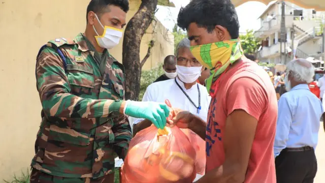 army personnel in sri lanka distributing vegetables to the public during the lokdown to prevent the spread of coronavirus