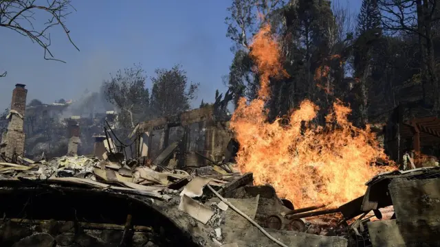 Fires continue to burn in destroyed homes during the "Skirball Fire" which began early morning in Bel-Air, California, USA, 06 December 2017.