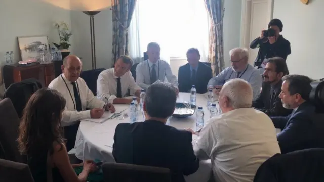Officials including President Macron and Javad Zarif around round table in Biarritz