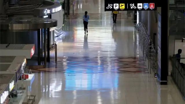 People are seen at Bangkok"s Suvarnabhumi International Airport as Thailand temporarily banned all passenger flights from landing in the country to curb the outbreak of the coronavirus disease (COVID-19)