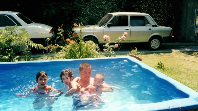 Gastón Riva con sus hijos en la piscina.