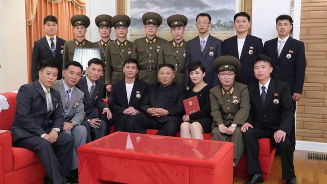 A photo released by the official North Korean Central News Agency (KCNA) on 12 July 2021 shows North Korean leader Kim Jong-Un (front C) meeting and congratulating creators and artistes of major art troupes who have received state commendations in Pyongyang, North Korea, 11 July 2021.