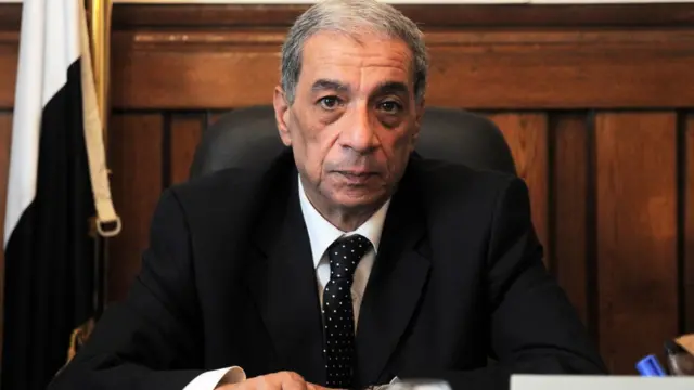 Ifoto y'umushinjacaha wa republika, Hesham Barakat, yafatiwe mu biro vyiwe itariki 10/07/2013, imbere y'uko agandagurwa ahitanywe n'igisasa gikomeye catewe ku muduga wiwe itariki 28/06/2015