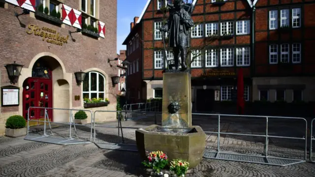 Flowers placed at a statue near the scene of the attack