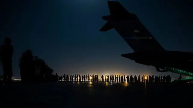 An air crew prepares to load evacuees at Kabul airport in August 2021