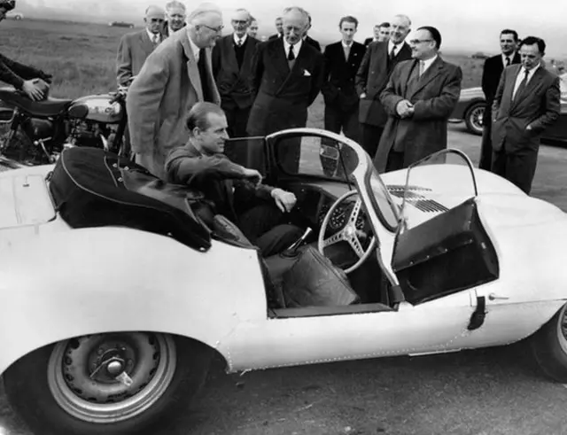 The Duke of Edinburgh is seen trying the passenger's seat of the new 3.5 litre Jaguar XKSS sports car during his visit to the Motor Industry Research Association's headquarters near Nuneaton, Warwickshire / Copyright: PA