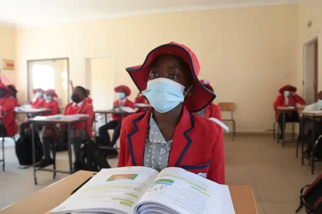 A student wears a face mask as she attends a lesson at the Oceanwaves Junior School just outside Harare, Zimbabwe, 30 August 2021. Schools have in Zimbabwe reopened for examination writing classes only after four months of a forced closure due an upsurge in the number of COVID-19 cases