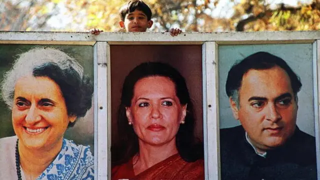 Sonia Gandhi (C), framed by former Indian prime minister Indira Gandhi (L) and Sonia's slain husband Rajiv Gandhi (R)