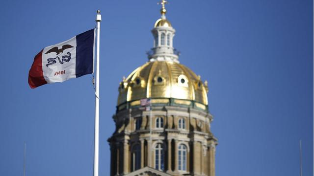 The Iowa state flag flies outside the State Capitol building