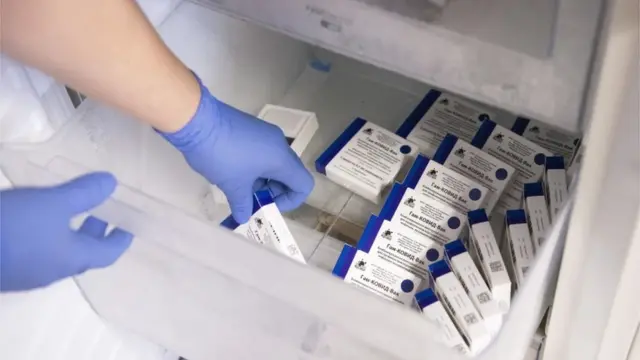 Boxes of the Russian vaccine Sputnik V are taken from a freezer at a hospital in Hungary