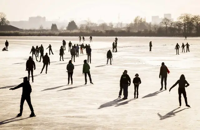 People skate on natural ice in Zuiderwoude, The Netherlands, 11 February 2021.