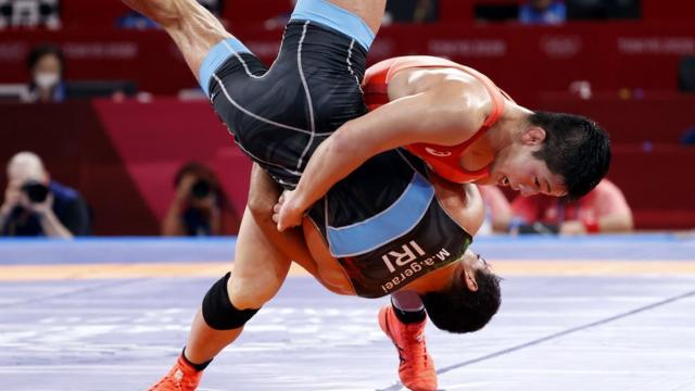 Shohei Yabiku of Japan (L) in action against Mohammadali Geraei of Iran (R) in the Men's Greco-Roman 77kg bronze medal match of the Wrestling events of the Tokyo 2020 Olympic Games at the Makuhari Messe convention centre in Chiba, Japan, 03 August 2021