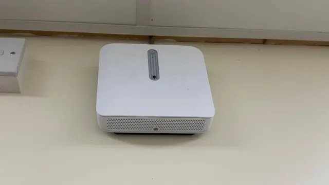 Una caja blanca cuadrada está instalada en la pared de un baño en una escuela secundaria de Gales con un sensor que detecta el vapeo dentro del espacio.