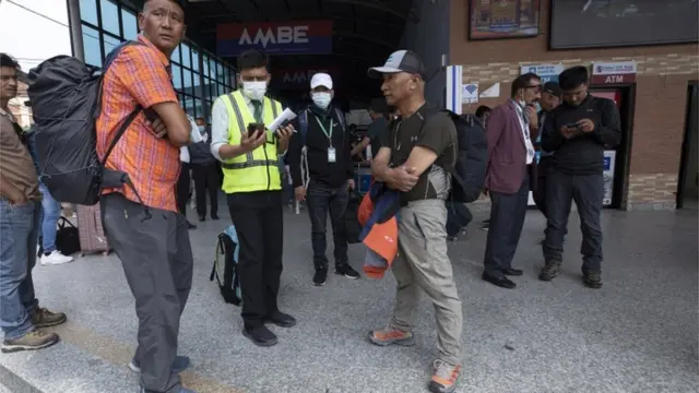Nepalese sherpas of di rescue team wait for oda colleagues as dem head to search for di remains of di Tara Air plane crash at Kathmandu Airport in Kathmandu, Nepal, 29 May 2022