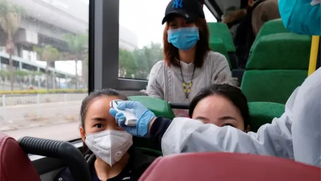 香港天水围一辆巴士上测量体温。