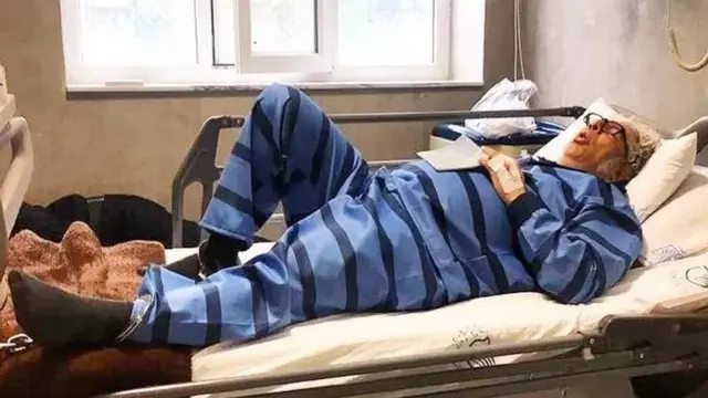 بکتاش آبتین با پاهای زنجیر شده به تخت بیمارستان