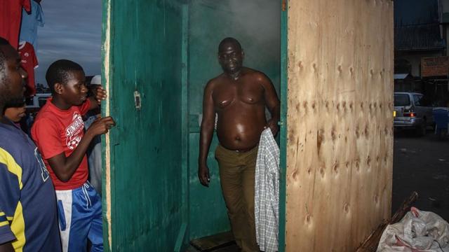 A man leaves a steam inhalation booth in Dar es Salaam, Tanzania, on 22 May, 2020