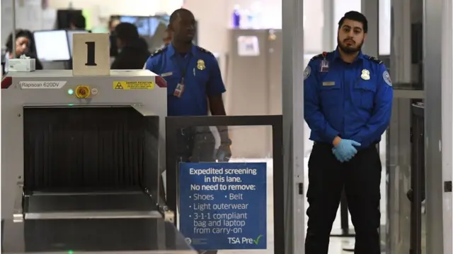 Transportation Security Administration officers (TSA) stand on duty at the departure area of the Los Angeles International Airport in Los Angeles, California, on 5 January, 2019. - TSA staff are taking sick leave in record numbers since the partial government shutdown forced them to work without pay began on Deember 22, 2018.