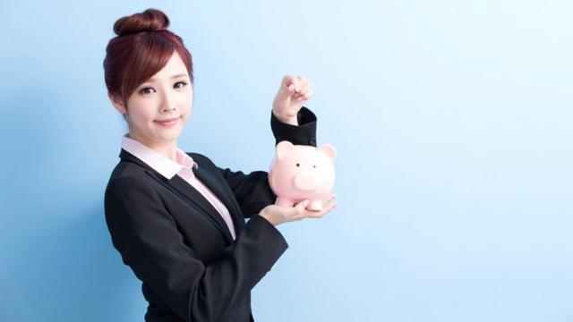 Japanese woman with piggybank