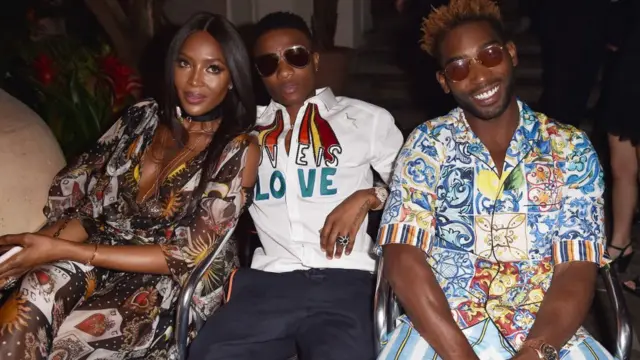 (L-R) Naomi Campbell, Wiz Kid and Tinie Tempah attend Dolce & Gabbana Naked King secret show for Milan Men Fashion Week