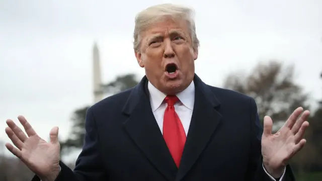 President Donald Trump answers questions from the press while departing the White House in Washington DC on 26 November 2018