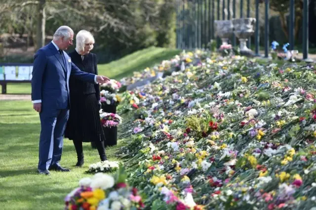 Prince Charles and Camilla, Duchess of Cornwall, visit the gardens of Marlborough House to view the flowers and messages left by members of the public outside Buckingham Palace following the death of Britain"s Prince Philip, in London