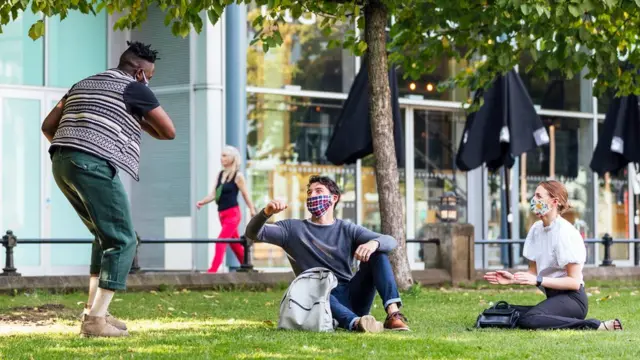 Friends meeting outside socially distanced