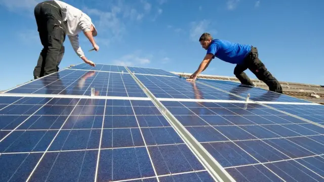 عمال أثناء تركيب لوحات الطاقة الشمسية