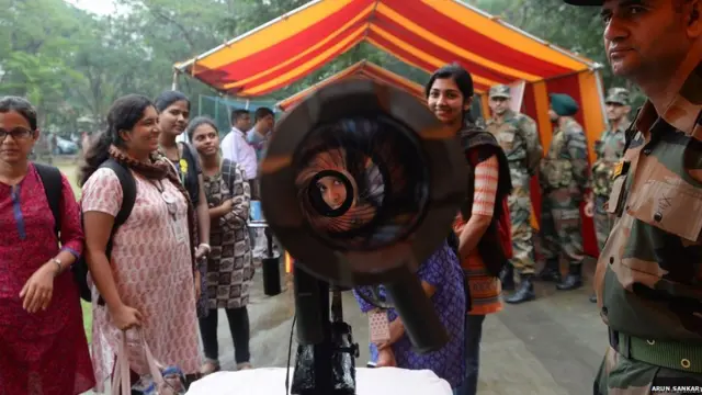 2. An Indian student looks into a rocket launcher during the Army Day celebration at a college in Chennai (