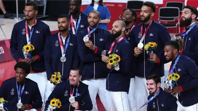 L'équipe de France masculine de basket-ball pose avec les médailles d'argent des Jeux olympiques de Tokyo 2020.