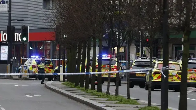 Police officers at the scene after a man was shot and killed by armed police