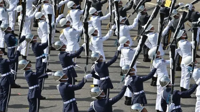 Military honour guards perform during National Day celebrations in front of the Presidential Palace in Taipei on October 10, 2019