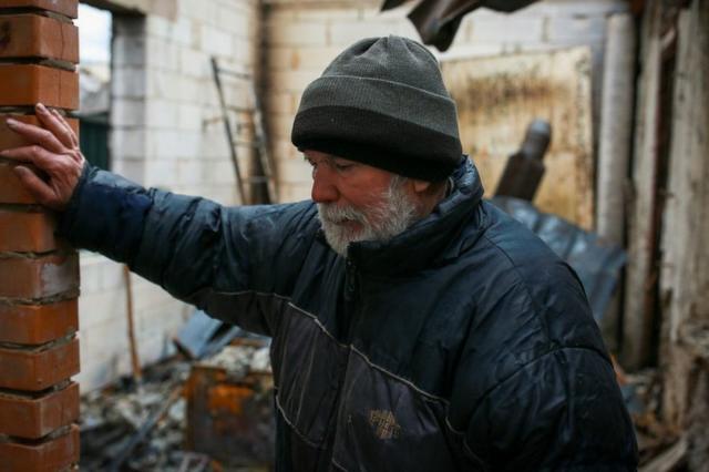 Volodymyr Abramov stands in the house once shared by his daughter and son-in-law