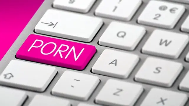 Keyboard with a pink key that reads "porn"
