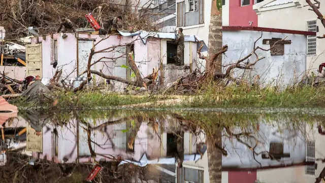 Assault Engineers from 40 Commando Royal Marines helping to fix up Alvin and Dorothy Nibbs" house in Road Town, Tortola