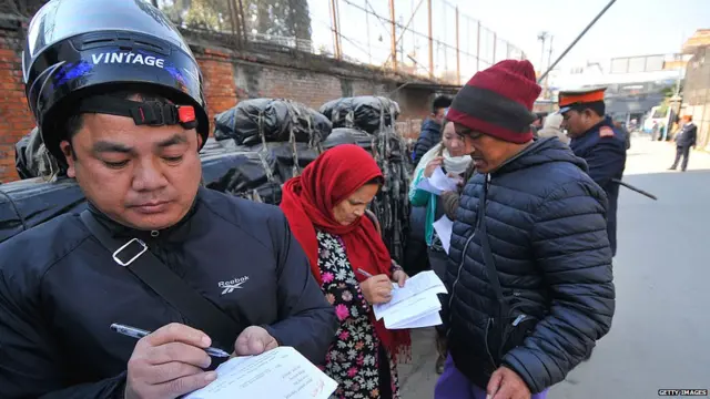 Nepalese people filling form exchange Indian currency at Nepal Rastra Bank