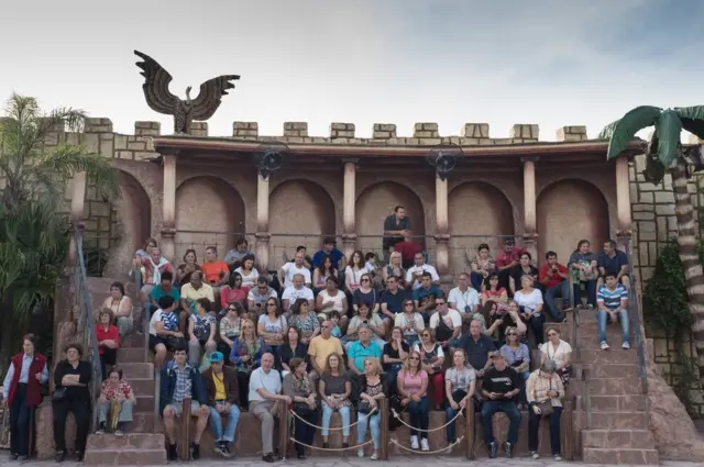 An audience sit in an amphitheatre