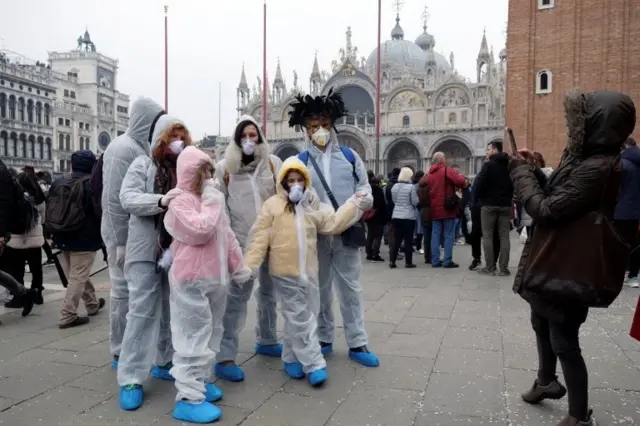Carnival revellers wear protective face masks at Venice Carnival