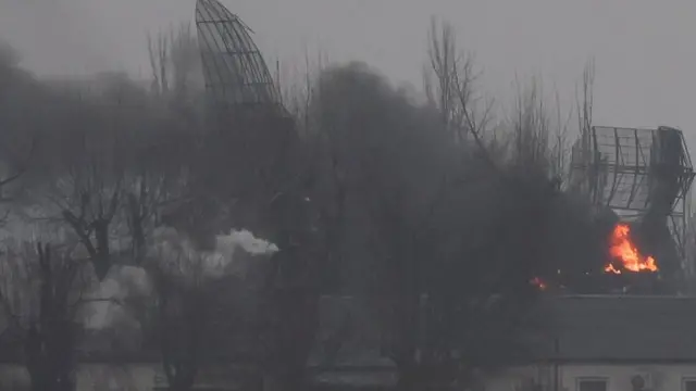 Fire is seen coming out of a military installation near the airport, after Russian President Vladimir Putin authorized a military operation in eastern Ukraine, in Mariupol, February 24, 2022.