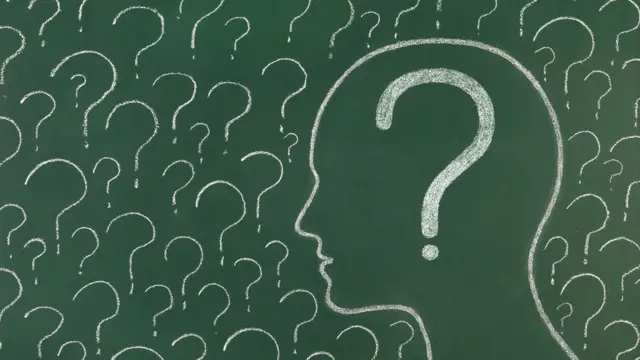 Silhouette of a person on a chalk board with a question mark