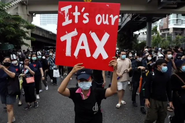 A pro-democracy protester holds a banner during an anti-government protest, in Bangkok, Thailand October 17, 2020.