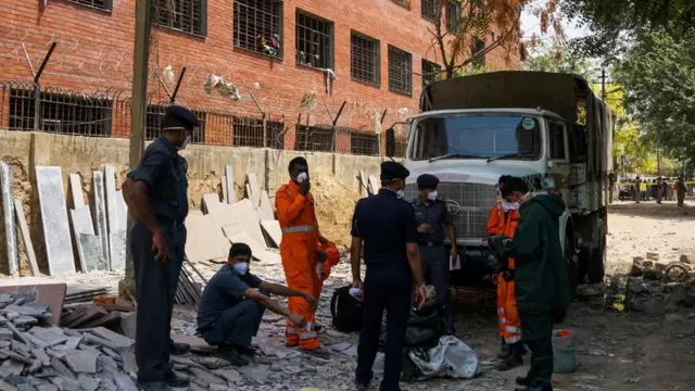 Members of the National Disaster Response Force (NDRF) prepare to take part in the clean-up operation at a container depot, where a gas leak occurred, in New Delhi on May 6, 2017. Around 100 students were sent to a hospital from their school on May 6 after the leak, with some of them unconscious and others suffering from nausea and irritation in eyes. / AFP PHOTO / Chandan KHANNA (Photo credit should read CHANDAN KHANNA/AFP/Getty Images)