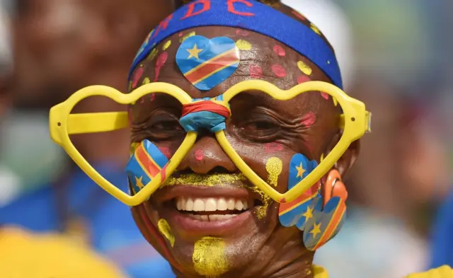 A DR Congo football fan wearing yellow heart rimmed glasses frames in Oyem, Gabon - Sunday 29 January 2017