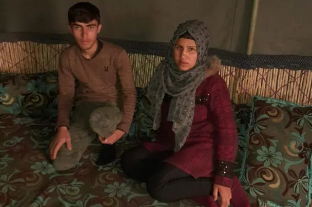 Dima and her husband Abdul Majid stand in their earthquake-destroyed home in Jindayris, Syria