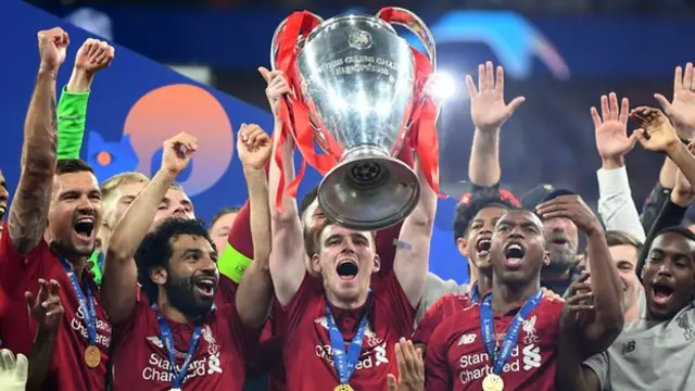 Andy Robertson lifting trophy