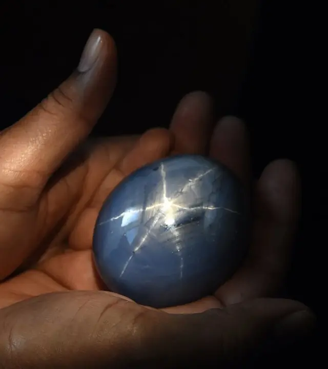 The worlds biggest blue star sapphire, the Lankan Star of Adam, is shown by its owner in Colombo on January 8, 2016. A Sri Lankan gem trader who owns the world's largest blue star sapphire has decided to sell the dazzling stone, with a dizzying asking price of $300 million. AFP PHOTO/Ishara S. KODIKARA / AFP / Ishara S.KODIKARA (Photo credit should read ISHARA S.KODIKARA/AFP via Getty Images)