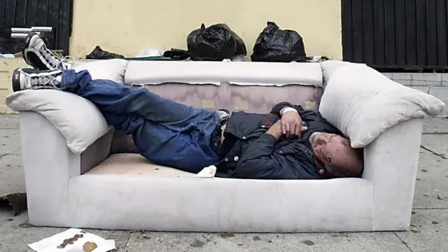 Man sleeping on a sofa on an LA street