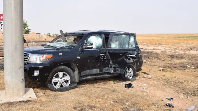 An armoured car covered in shots on the left-hand side