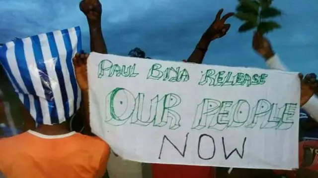 protesters carry banner