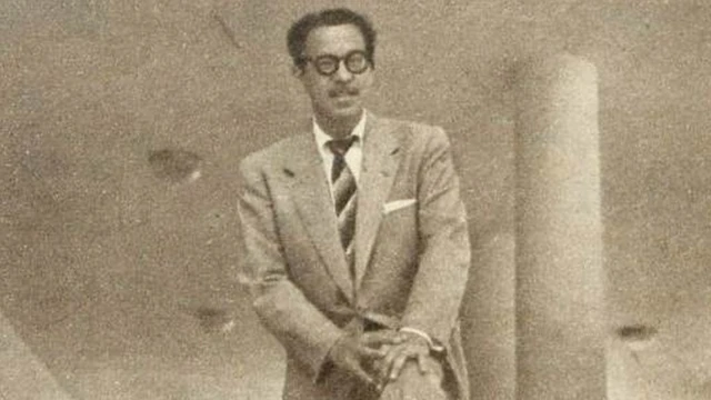 Em foto preto e branca, Vadico posa em pé, aparentemente em saguão de um prédio